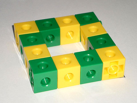 A hollow square, with each side consisting of a line of green-yellow-green-yellow cubes.