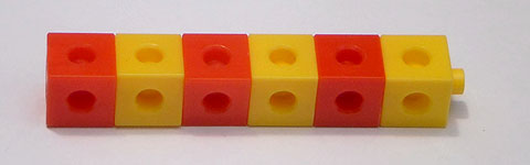 Six cubes, alternating in colour between red and yellow.