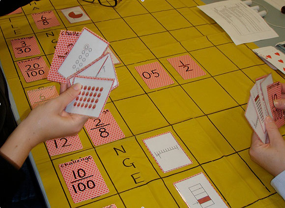 Board game, with cards showing fractions, decimal fractions, area models and number lines.