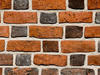 A brick wall with each row alternating short and long bricks.